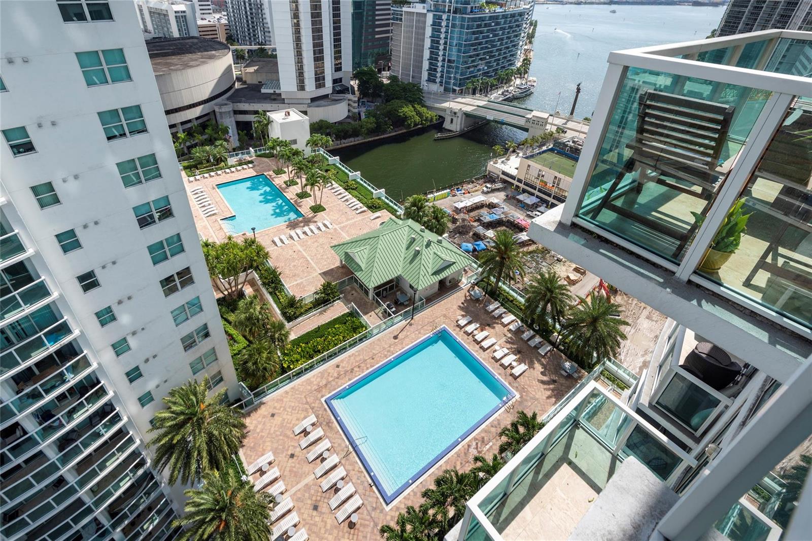 An elevated view shows two swimming pools, a green-roofed building, and a nearby river — 41 SE 5th Street # 1315, Miami FL 33131, MIAMI, FL