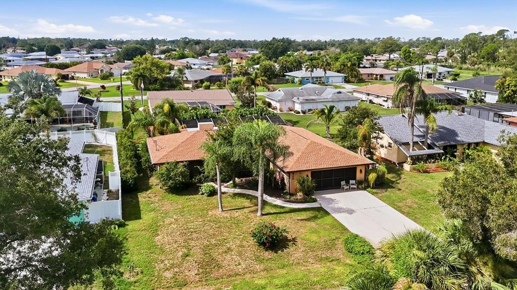 An aerial view shows a single-story house with a brown roof and a concrete driveway — 925 N BOUNDARY ROAD, ENGLEWOOD, FL