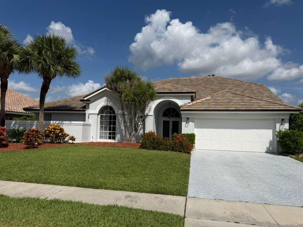 A single-story house with a white stucco exterior, tile roof, and a two-car garage — 22257 Collington Drive, Boca Raton FL 33428, BOCA RATON, FL