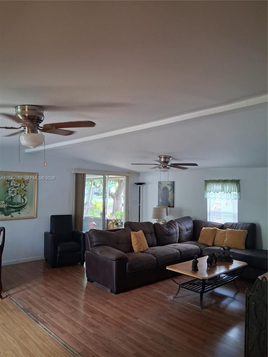 A living room features a brown sectional sofa, a coffee table, and two ceiling fans — 5030 SW 30th Ave, Dania Beach FL 33312, DANIA BEACH, FL