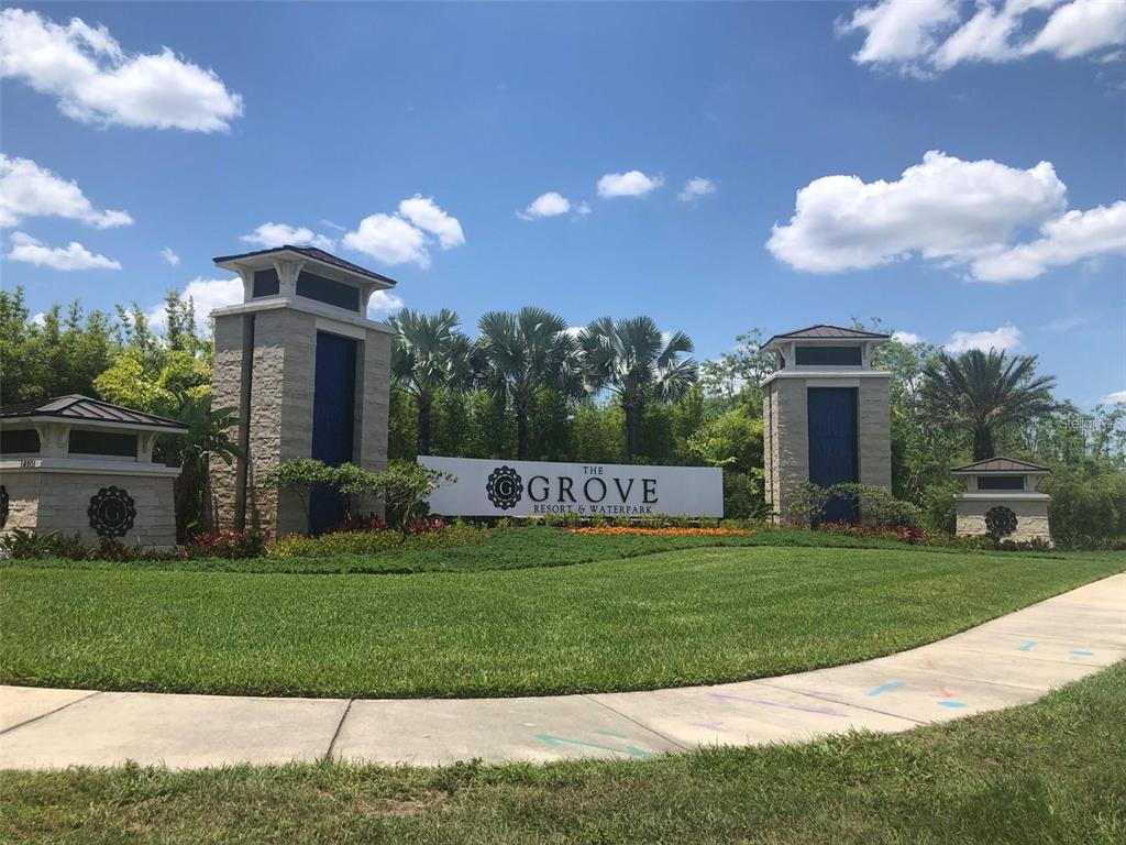 The entrance sign for The Grove Resort & Waterpark features stone pillars and landscaping — 14501 GROVE RESORT AVENUE UNIT 2527, WINTER GARDEN, FL
