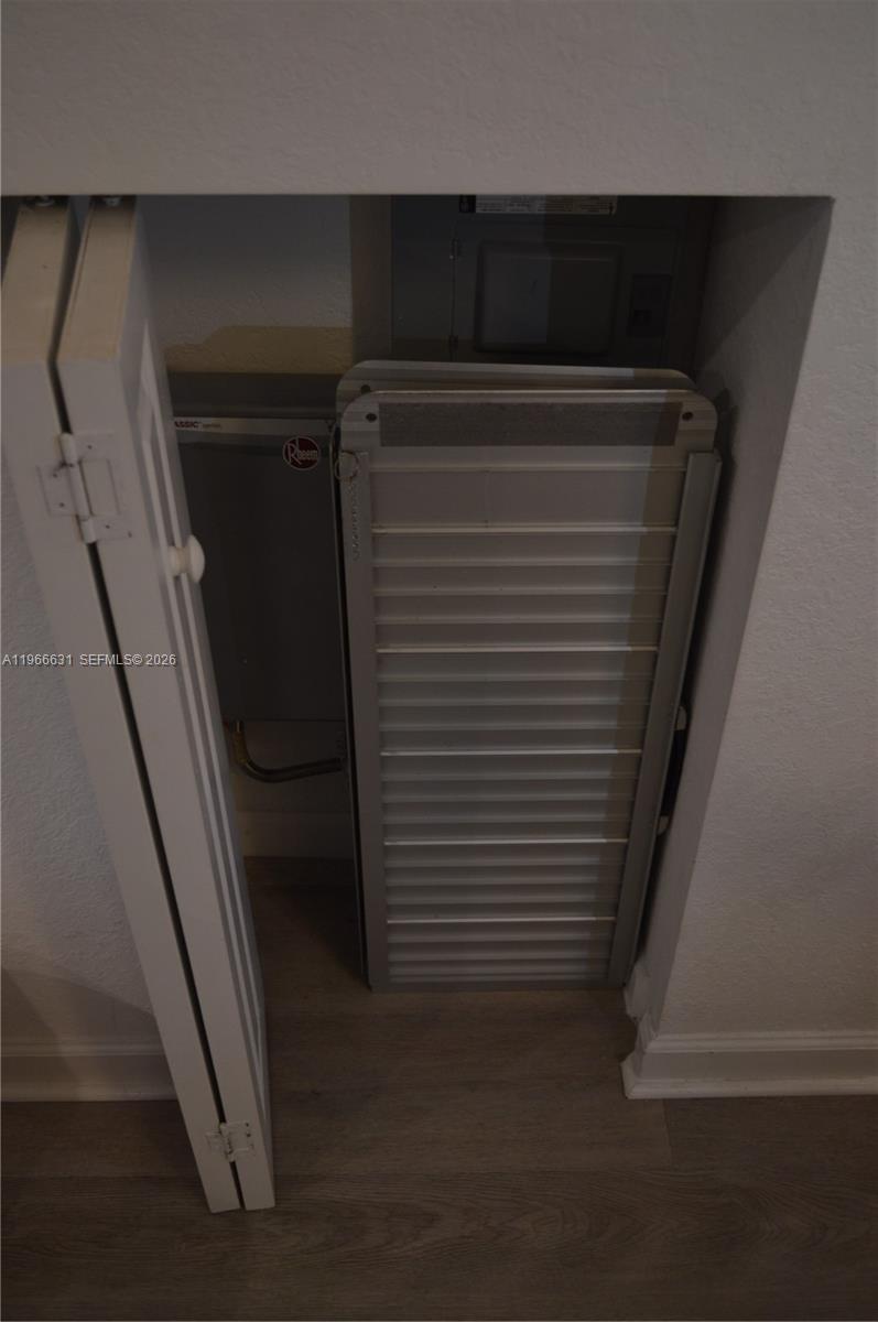 A closet contains an electrical panel and a Rheem water heater — 1522 SE 26th Ter, Homestead FL 33035, HOMESTEAD, FL