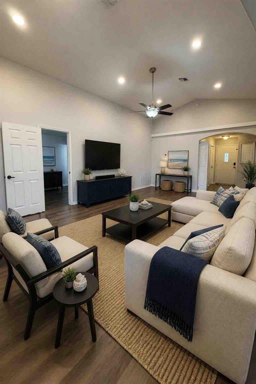 A living room features a beige sectional, two armchairs, a coffee table, and a television — 2965 COOL BREEZE CIRCLE, ST CLOUD, FL