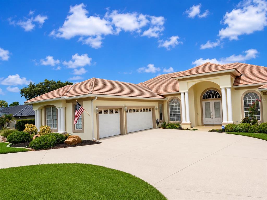 A single-story house with a two-car garage, tile roof, and a paved driveway — 150 OLD NICHOLS CIRCLE, AUBURNDALE, FL