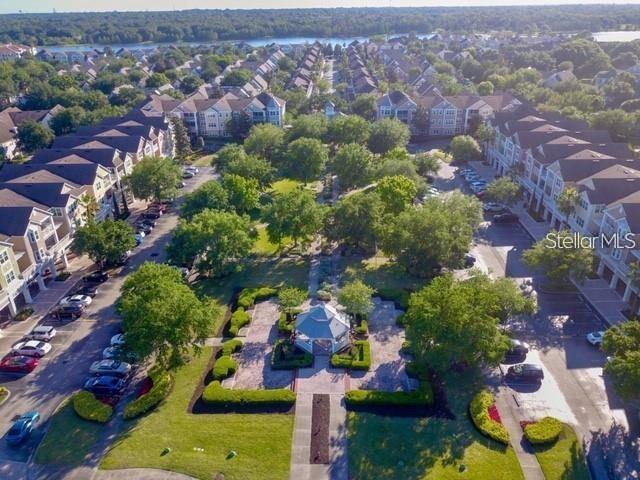 An aerial view shows a gazebo in a landscaped courtyard surrounded by multi-story apartment buildings — 6627 QUEENS BOROUGH AVENUE UNIT 108, ORLANDO, FL