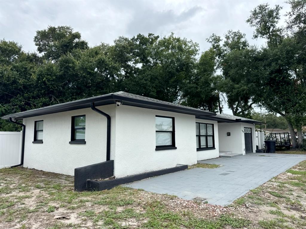 A white stucco house with black trim and a gray paved driveway — 3780 51ST STREET N, ST PETERSBURG, FL