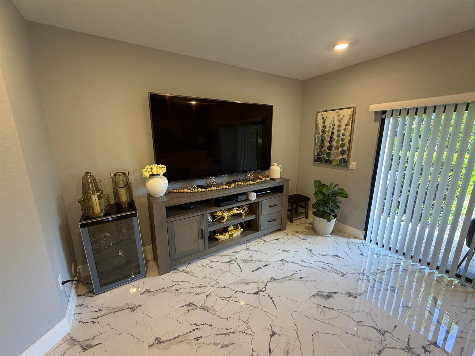 A living room features a large television on a wooden console, a wine cooler, and marble flooring — 178 SE 5th Court SE, Deerfield Beach FL 33441, DEERFIELD BEACH, FL