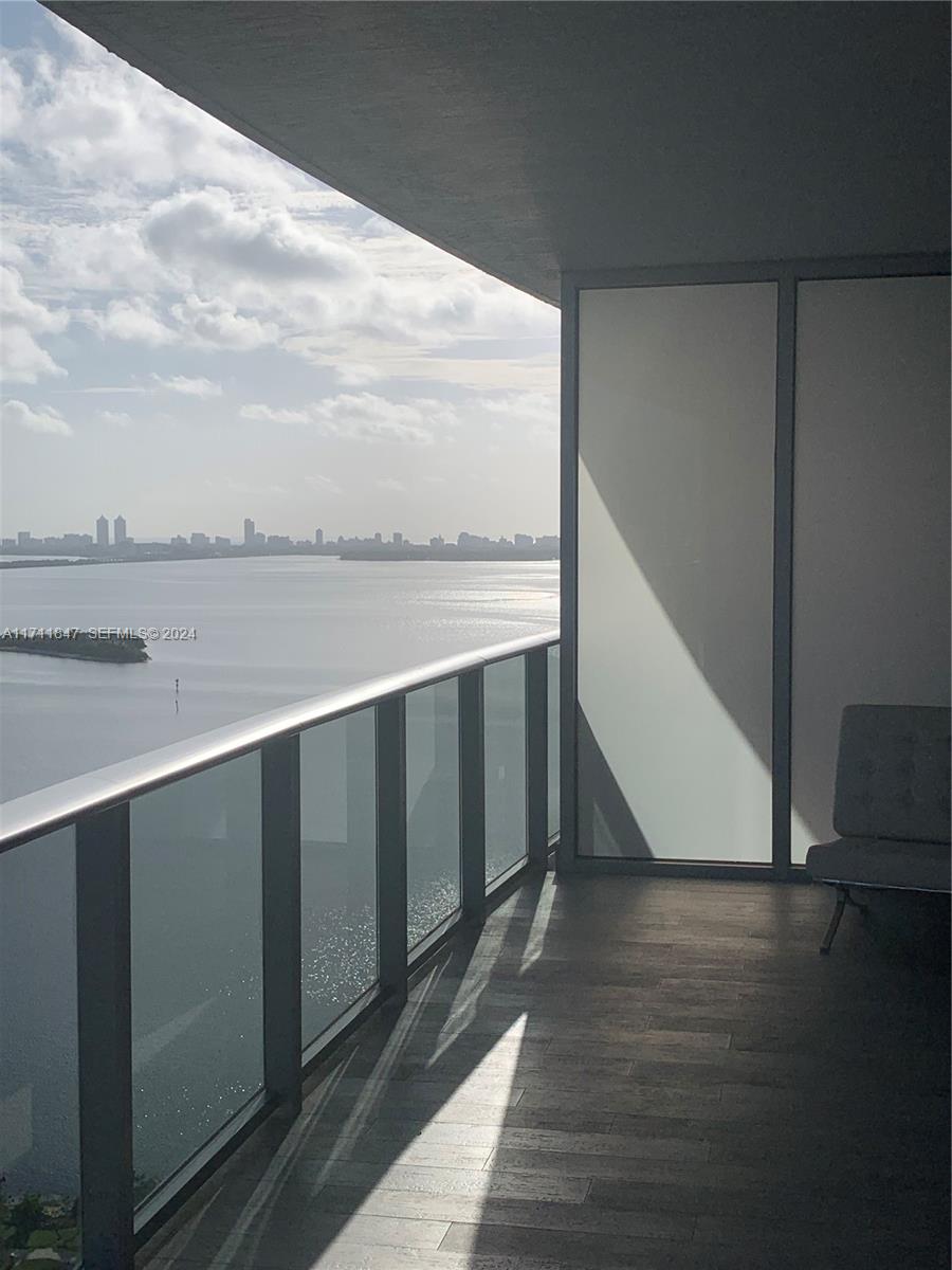 A balcony with a glass railing overlooks a bay and city skyline — 488 NE 18th St # 2705, Miami FL 33132, MIAMI, FL