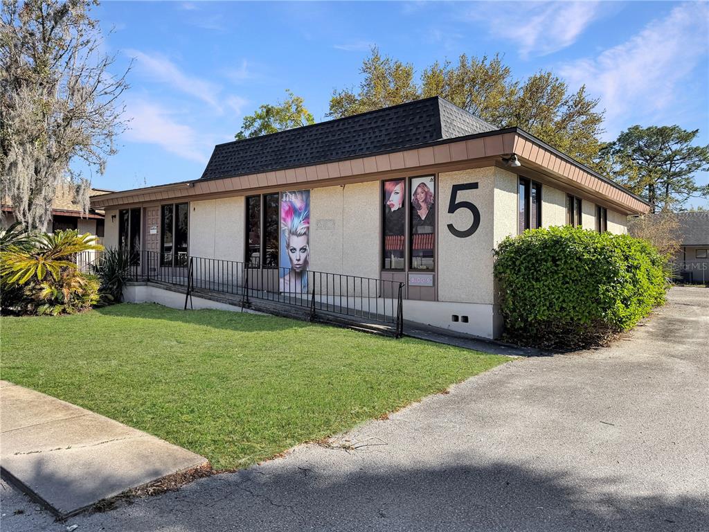 A single-story commercial building with a ramp, large windows, and a prominent number five — 4131 UNIVERSITY BOULEVARD S UNIT 5, JACKSONVILLE, FL