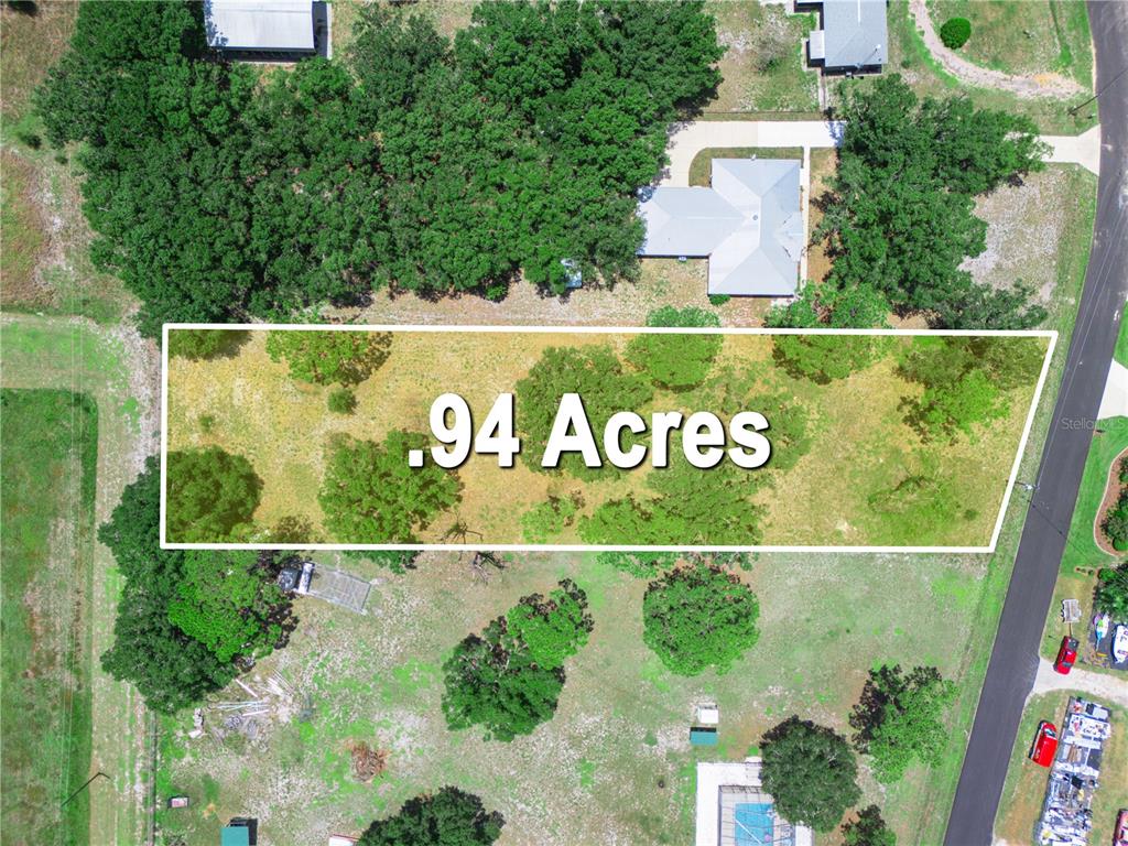 This aerial view shows a rectangular plot of land measuring .94 acres — 735 KEEN ROAD, FROSTPROOF, FL