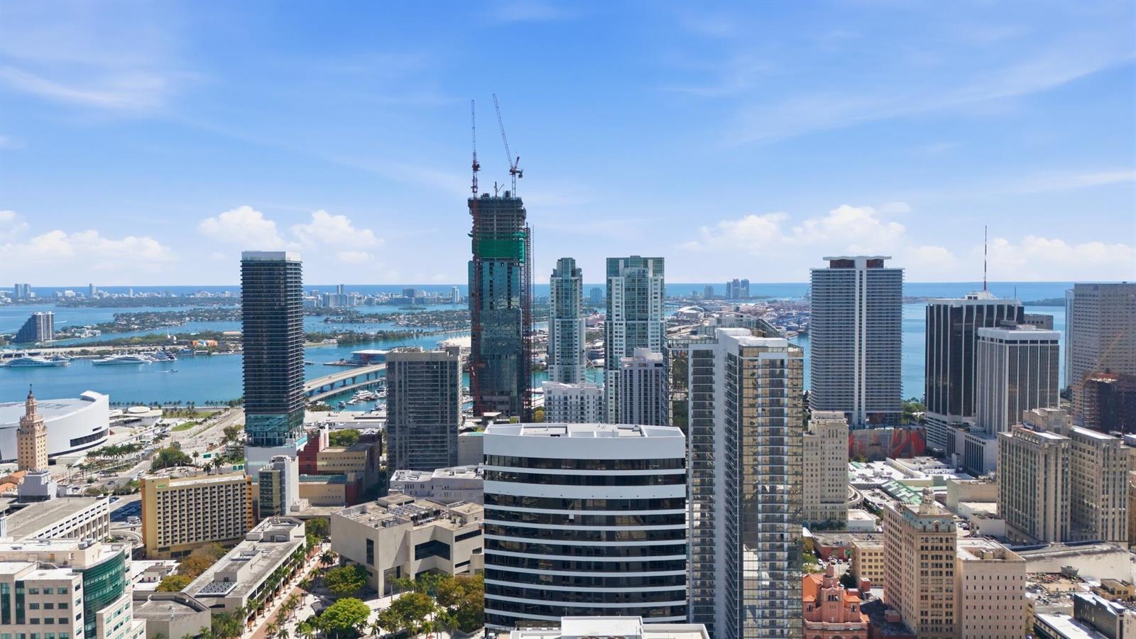 An aerial view of the Miami skyline featuring numerous high-rise buildings and a construction crane — 225 N Miami Avenue # 2002, Miami FL 33128, MIAMI, FL