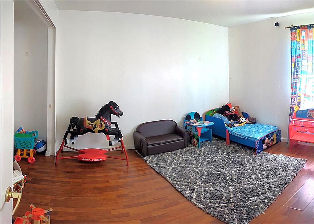 A child's bedroom features hardwood floors, a rocking horse, a small bed, and a rug — 2908 EGRETS LANDING, LAKE MARY, FL