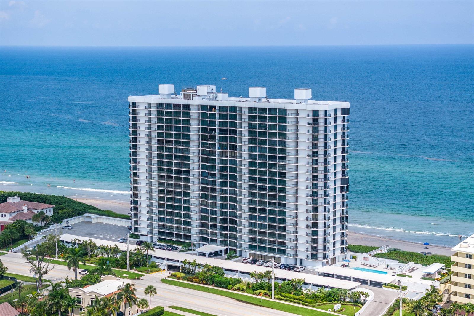 An aerial view of a tall white residential building situated directly on the oceanfront — 250 S Ocean Boulevard, Boca Raton FL 33432, BOCA RATON, FL
