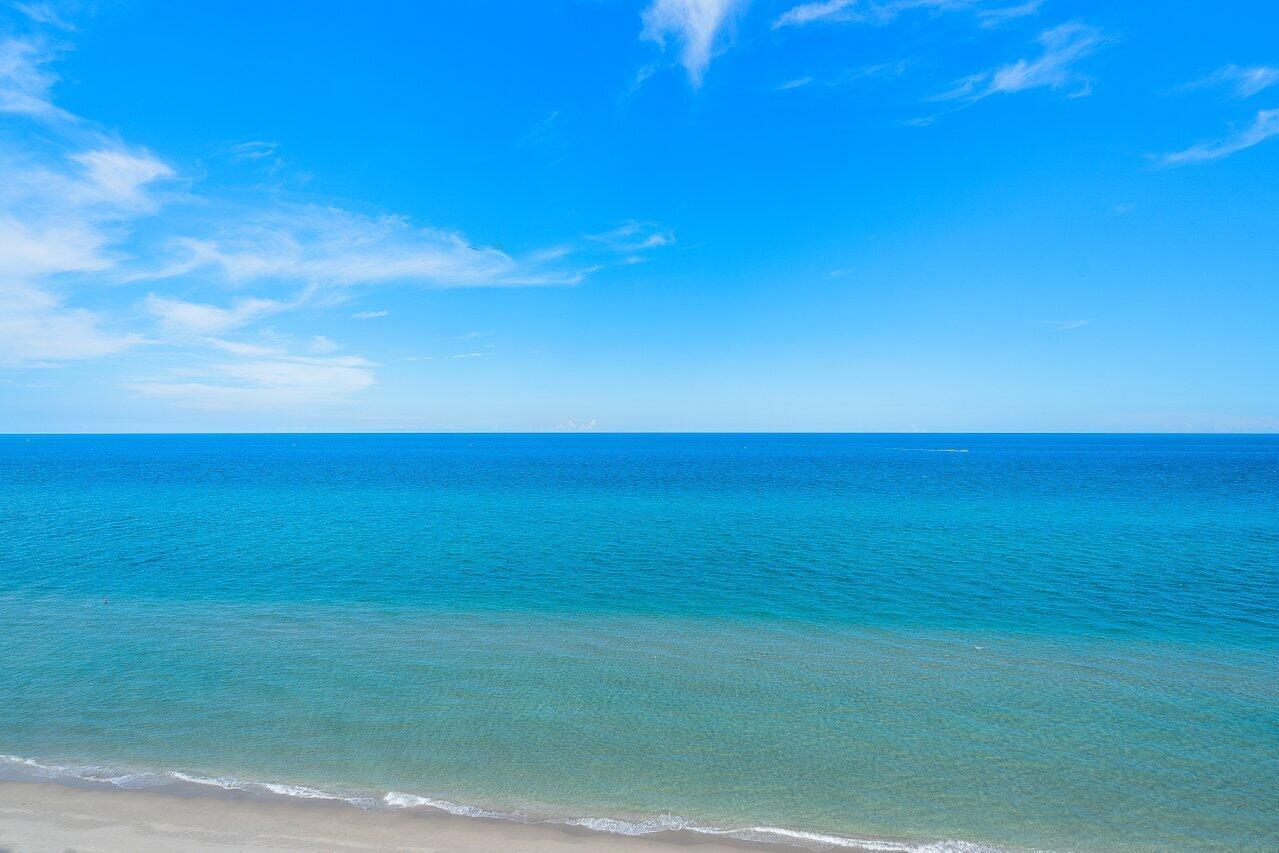 An elevated view of a sandy beach meeting the turquoise ocean under a blue sky — 250 S Ocean Boulevard, Boca Raton FL 33432, BOCA RATON, FL