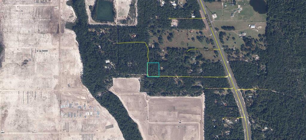 This is an aerial map showing a rectangular property parcel highlighted in blue near a highway — LANDRETH ROAD, GREEN COVE SPRINGS, FL