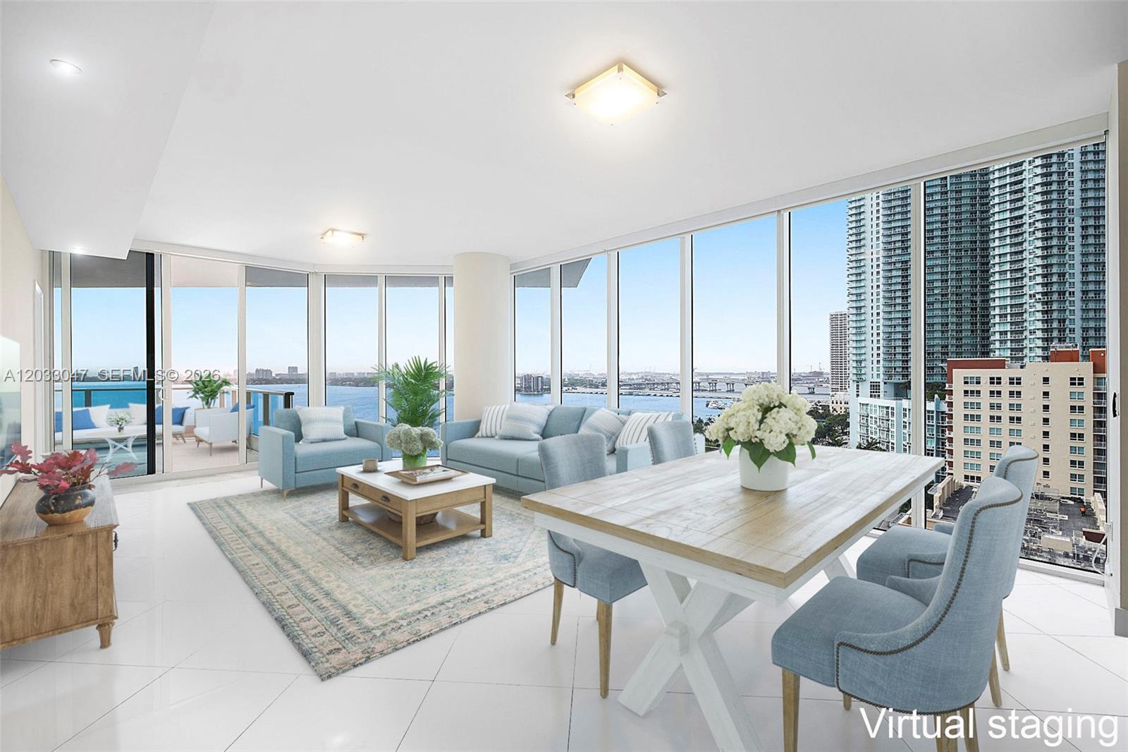 A living and dining area features floor-to-ceiling windows with water and city views — 2020 N Bayshore Dr # 1602, Miami FL 33137, MIAMI, FL