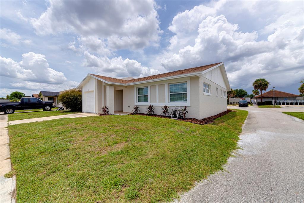 A single-story house with a beige exterior, a white garage door, and a grassy yard — 1100 CALANDA AVENUE, ORLANDO, FL