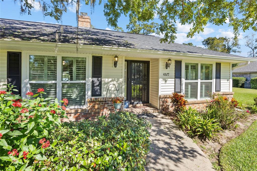 A single-story house with a brick and siding exterior, a front walkway, and landscaping — 4517 SE 2ND PLACE, OCALA, FL