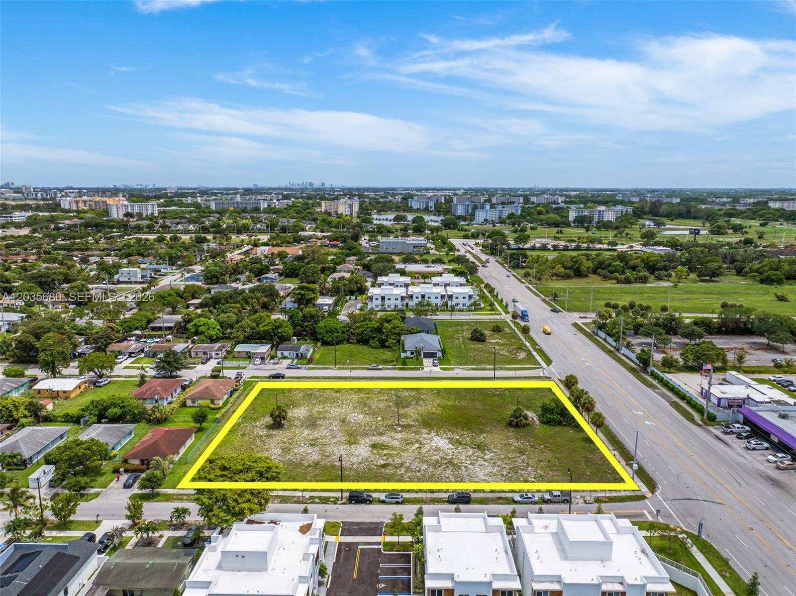 An aerial view shows a vacant rectangular lot outlined in yellow next to a road — NW 31st Ave, Pompano Beach FL 33069, POMPANO BEACH, FL