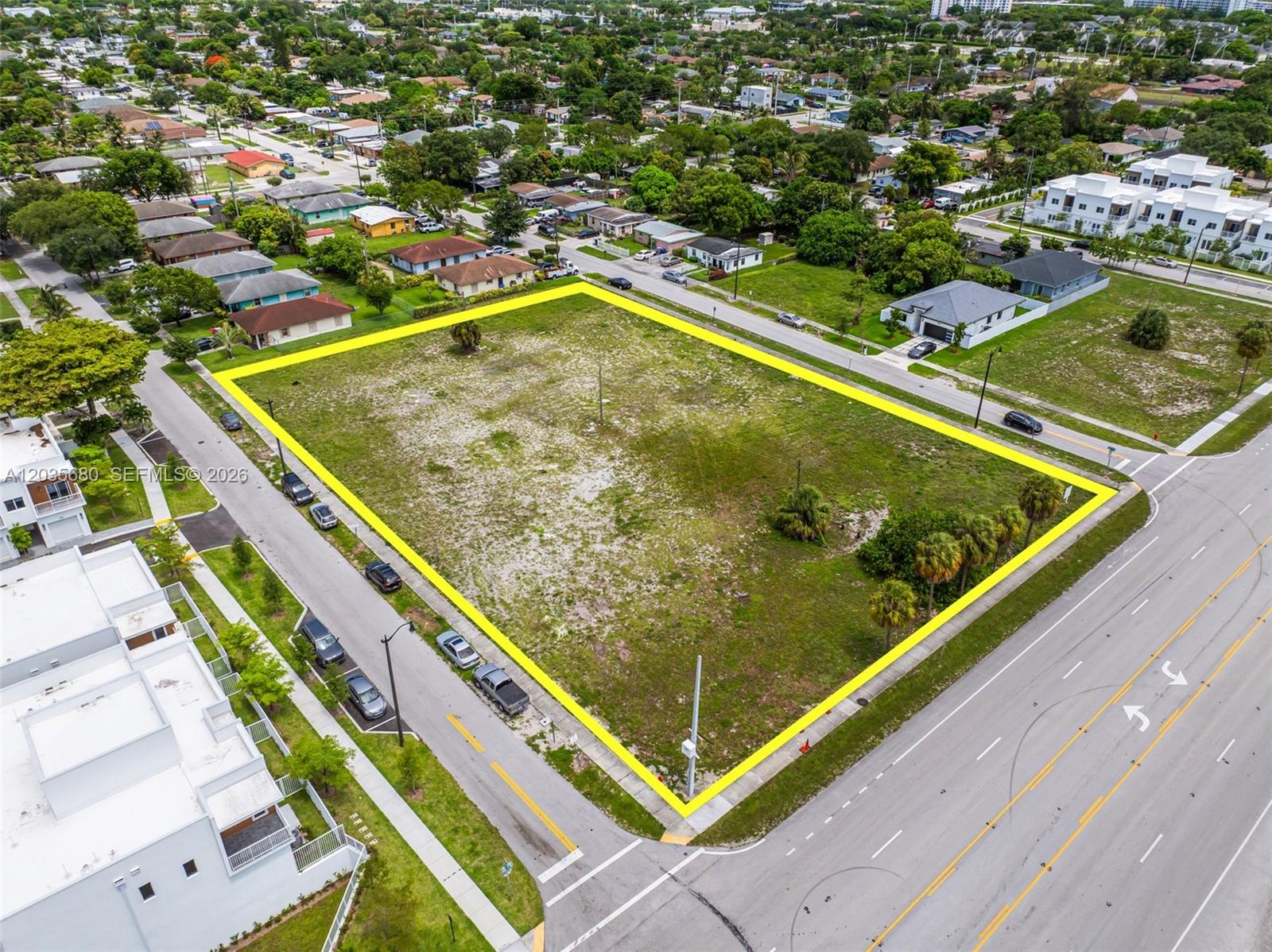 An aerial view shows a vacant, rectangular corner lot outlined in yellow — NW 31st Ave, Pompano Beach FL 33069, POMPANO BEACH, FL