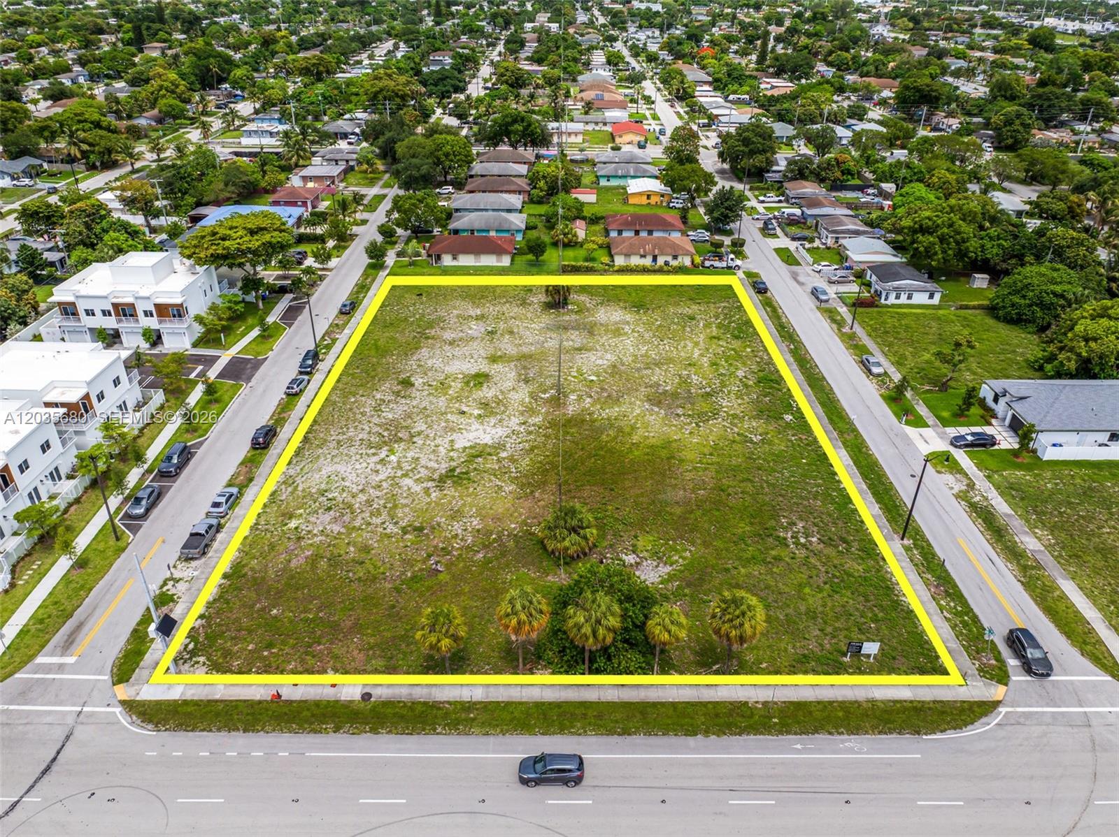 An aerial view shows a large, rectangular vacant lot outlined in yellow between two streets — NW 31st Ave, Pompano Beach FL 33069, POMPANO BEACH, FL