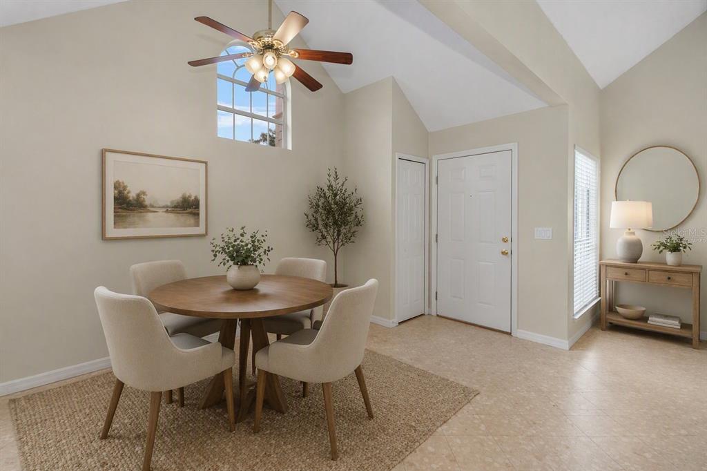 A dining area with a round wooden table, four chairs, and a vaulted ceiling — 605 YOUNGSTOWN PARKWAY UNIT 30, ALTAMONTE SPRINGS, FL