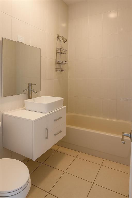 A bathroom features a white floating vanity, a vessel sink, and a tiled tub-shower combination — 3 CLARISA STREET UNIT 447, PONCE, PR