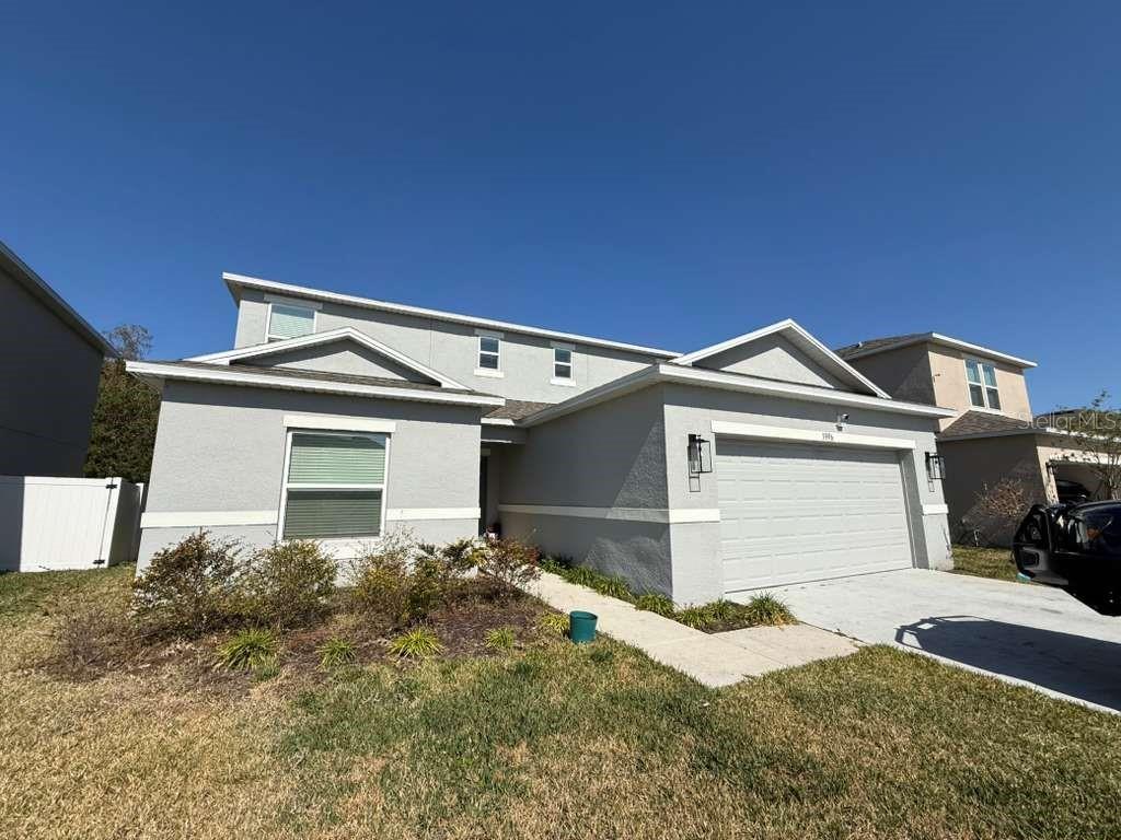 A two-story gray house with a two-car garage and a front walkway — 3996 SOUTHERN VISTA LOOP, ST CLOUD, FL