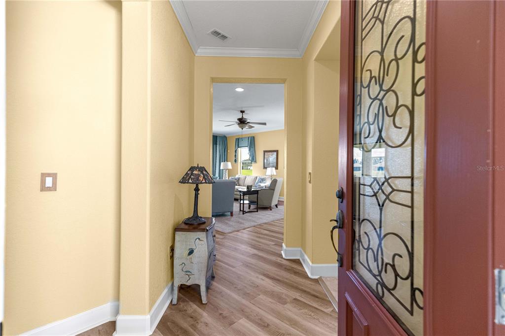 A view from an entryway looking into a living room with light-colored walls — 9530 SW 70TH LOOP, OCALA, FL