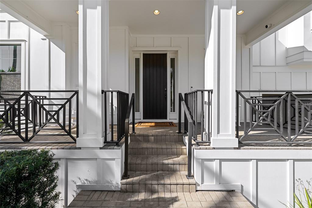 A front porch with white columns, black railings, and steps leading to a dark front door — 478 BOSPHOROUS AVENUE, TAMPA, FL