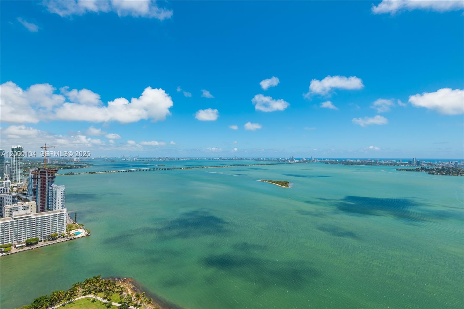An aerial view shows a large bay with a bridge, distant city skyline, and buildings — 488 NE 18th St # 4515, Miami FL 33132, MIAMI, FL