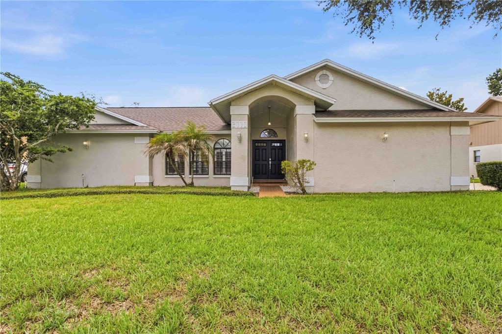 A single-story beige house with a covered entryway and a large front lawn — 2110 LAINDALE # PLACE, VALRICO, FL