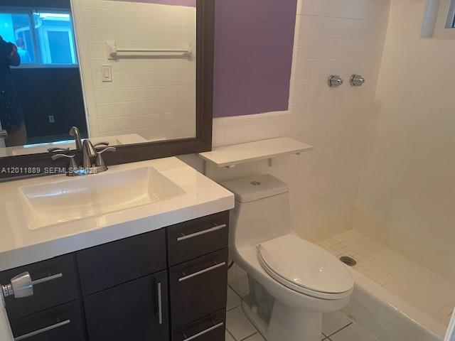 A bathroom features a dark wood vanity, a white vessel sink, and a walk-in shower — 4501 Mainland Dr, Tamarac FL 33319, TAMARAC, FL