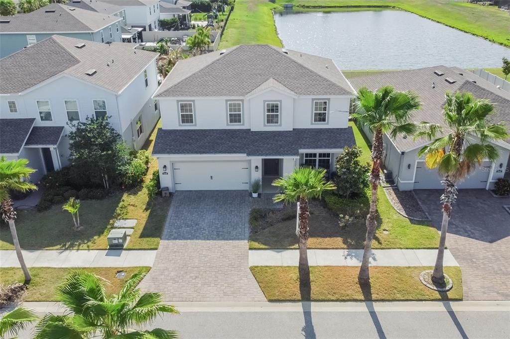 An aerial view of a two-story suburban house with a paved driveway and palm trees — 12349 BLUE PACIFIC DRIVE, RIVERVIEW, FL
