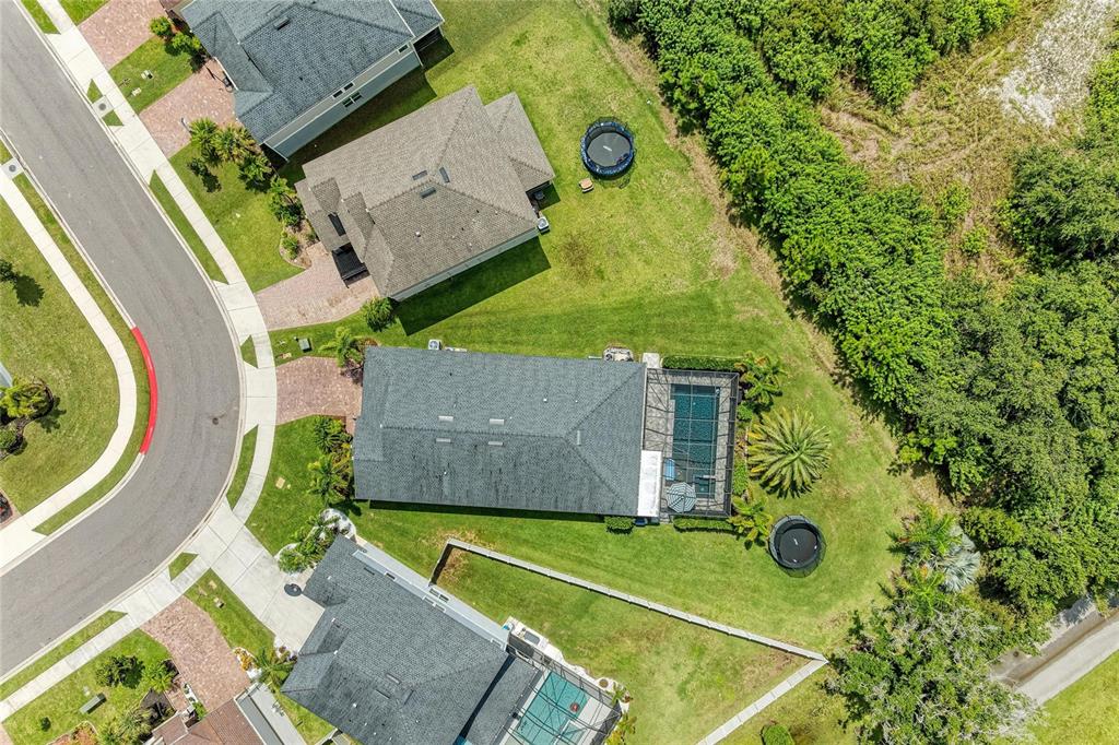 A screened-in patio features a swimming pool, a hot tub, and two chairs under an umbrella — 14405 59TH CIRCLE E, BRADENTON, FL