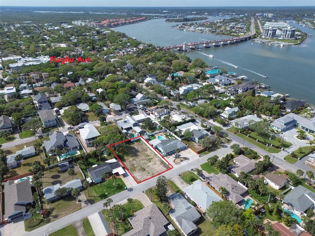 An aerial view shows a vacant rectangular lot outlined in red within a residential neighborhood — 209 NORMANDY AVENUE, NEW SMYRNA BEACH, FL