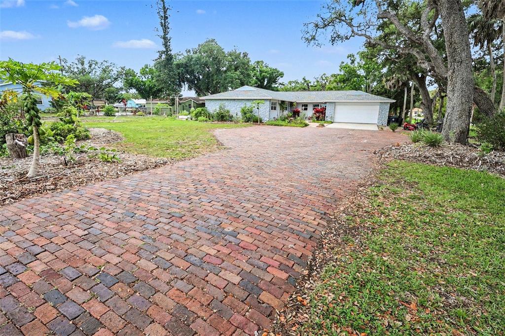 A living room features a sectional sofa, a fireplace with a television, and a console table — 1713 14TH AVENUE W, PALMETTO, FL