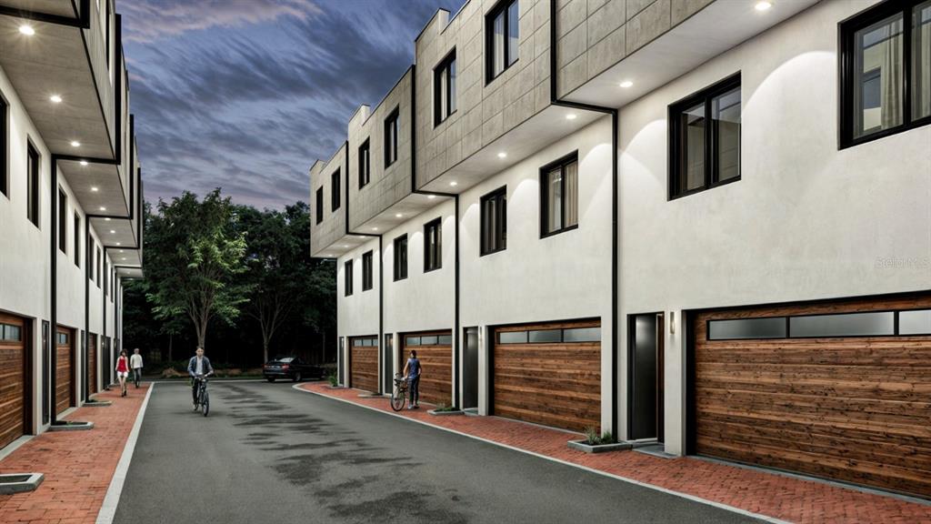 This is a rendering of a modern townhouse complex with wood garage doors and brick walkways — 10775 RODEO DRIVE UNIT tbd, LAKEWOOD RANCH, FL