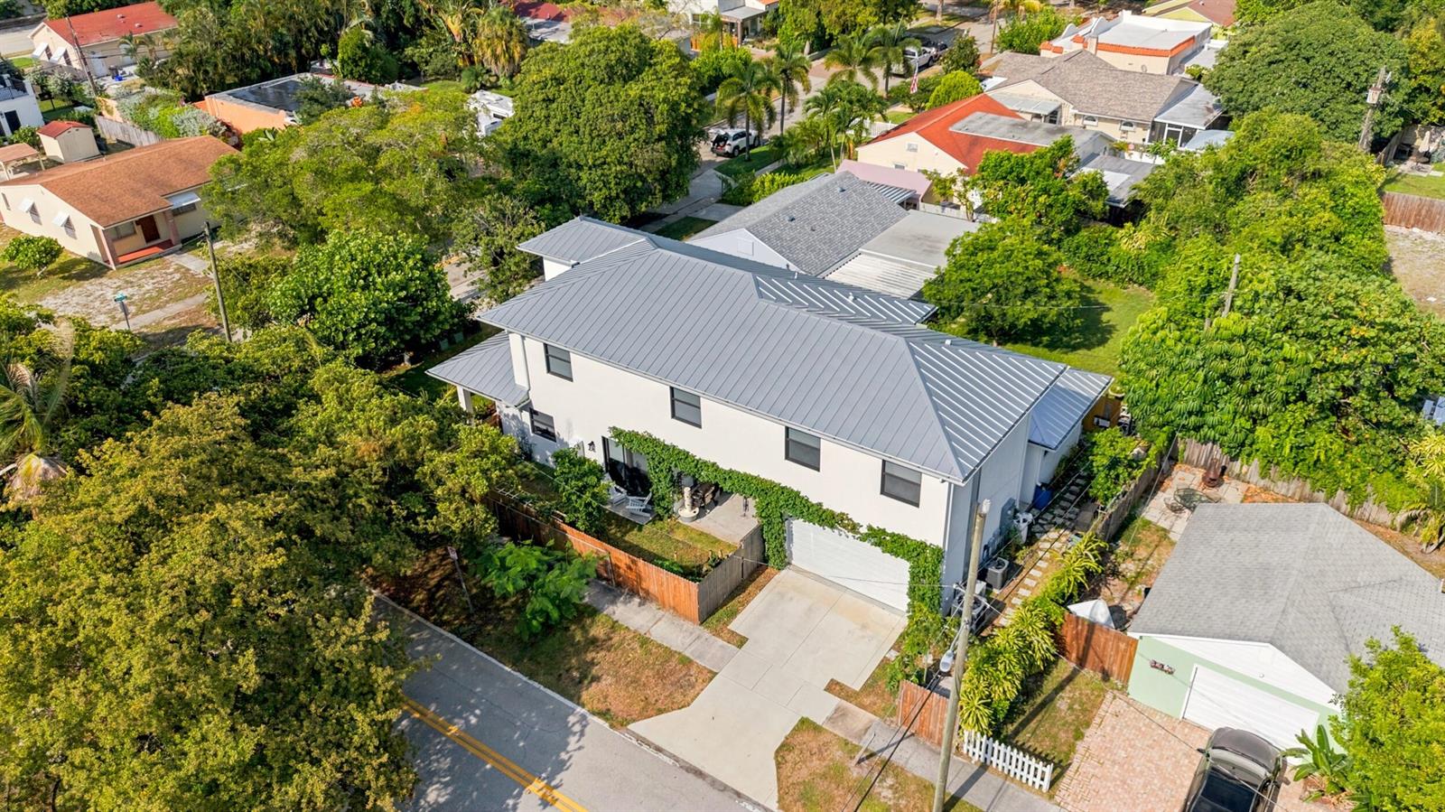 An aerial view of a two-story house with a metal roof and a driveway — 740 Winters Street, West Palm Beach FL 33405, WEST PALM BEACH, FL