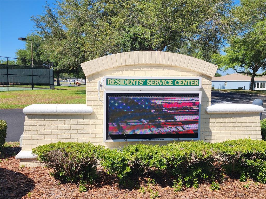A brick monument sign for the Residents' Service Center stands in front of a tennis court — 1715 SW 157TH PLACE ROAD, OCALA, FL