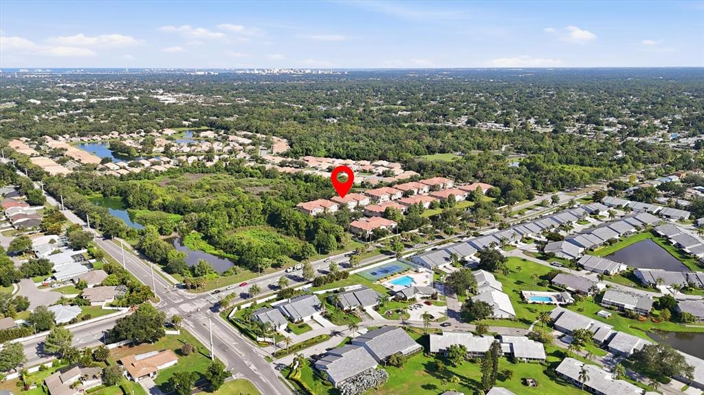 An aerial view of a multi-unit townhouse complex with tan stucco walls and tiled roofs — 4224 VIA PIEDRA CIRCLE UNIT 4-102, SARASOTA, FL