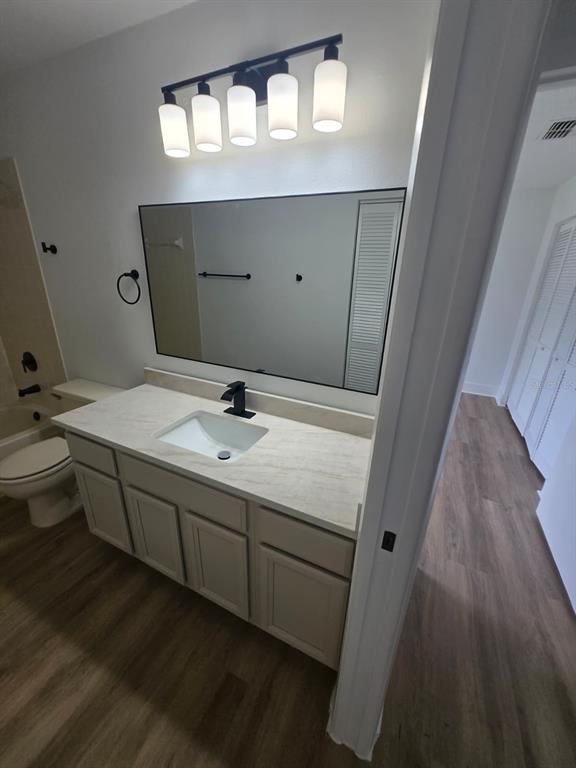 A bathroom features a vanity with a light-colored countertop, a mirror, and overhead lighting — 3448 GLEN ABBEY LANE, LAKELAND, FL