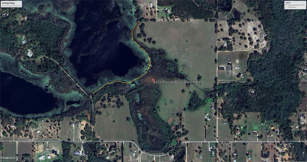 This is a satellite map showing a rural property with a lake and grassy fields — 8335 FLORIDA BOYS RANCH ROAD, GROVELAND, FL