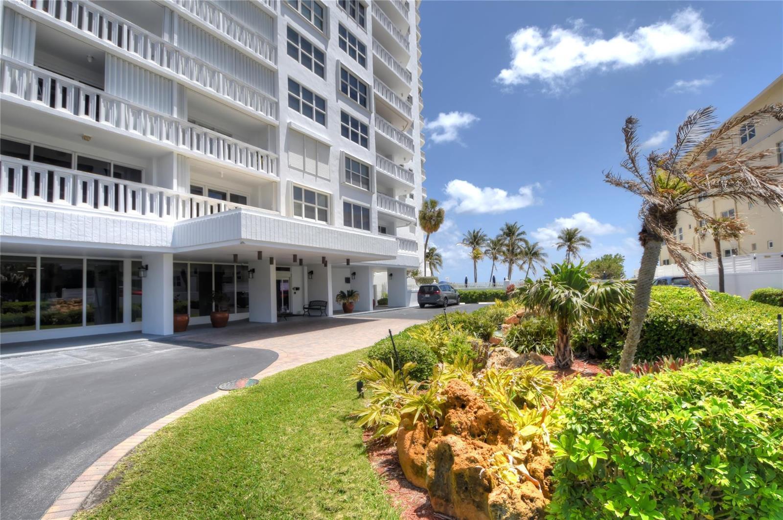 A multi-story white apartment building with a covered entrance and landscaped grounds — 1012 N Ocean Boulevard # 204, Pompano Beach FL 33062, POMPANO BEACH, FL