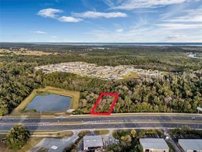 An aerial view shows a rectangular plot of land outlined in red near a highway — TBD US HIGHWAY 27/441, FRUITLAND PARK, FL