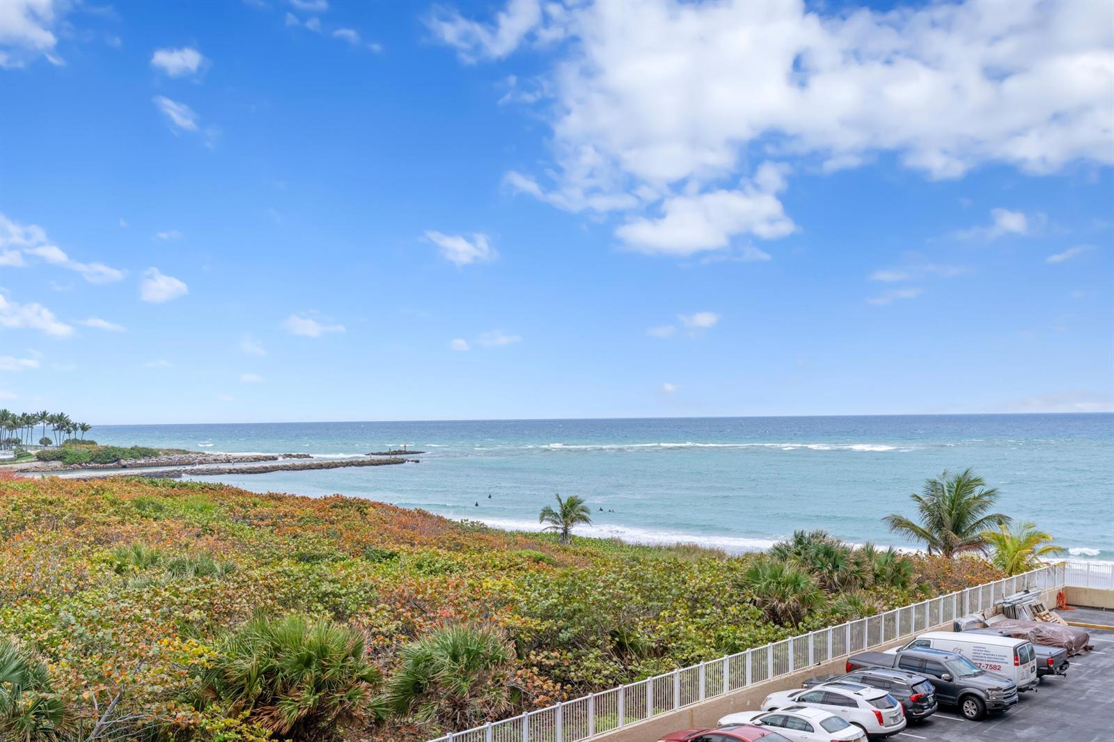 An elevated view shows a beach, ocean, and parking lot with several vehicles — 1180 S Ocean # 0044, Boca Raton FL 33432, BOCA RATON, FL