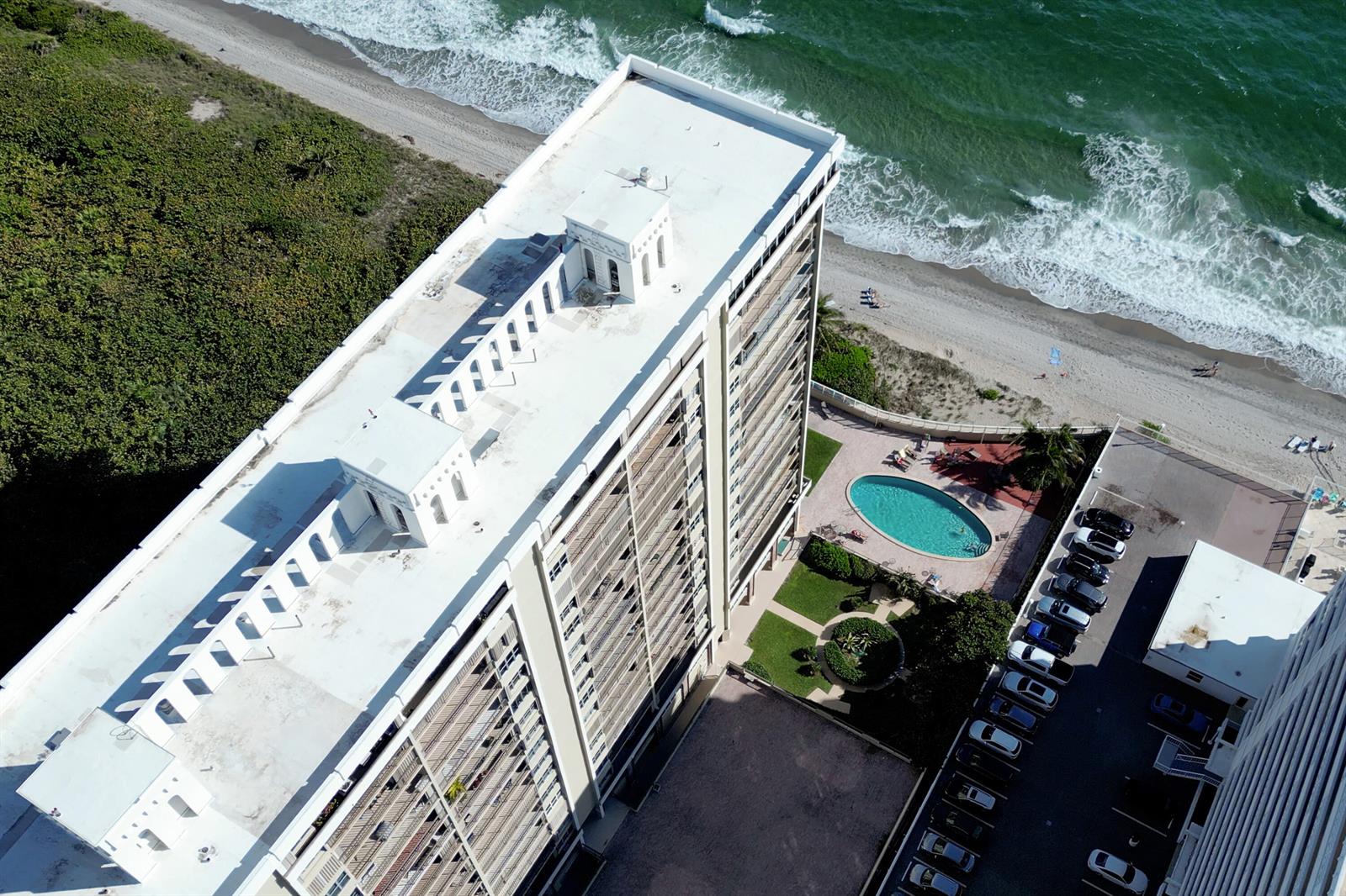 An aerial view of a high-rise building with a pool, parking lot, and beach access — 1180 S Ocean # 0044, Boca Raton FL 33432, BOCA RATON, FL