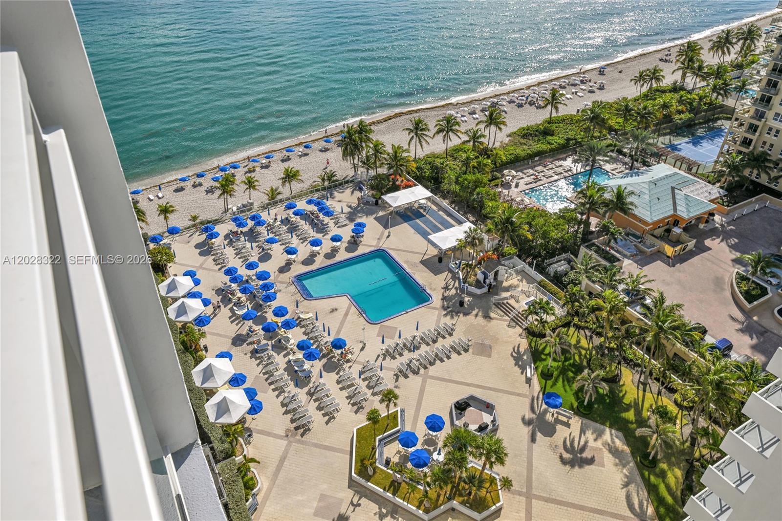 An aerial view shows a swimming pool, lounge chairs, and beach access at a resort — 2030 S Ocean Dr # 2018, Hallandale Beach FL 33009, HALLANDALE BEACH, FL