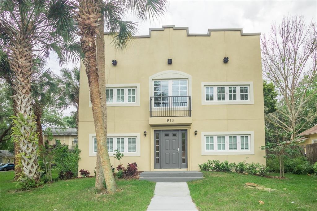A two-story tan stucco building with a central entrance and a small second-story balcony — 915 E PALMETTO STREET, LAKELAND, FL