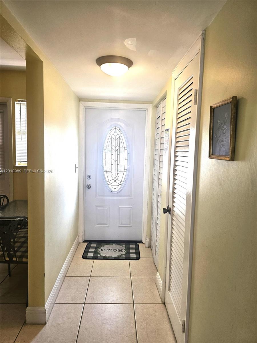 A tiled entryway features a white front door with a decorative glass insert — 2097 S Ocean Dr # 305, Hallandale Beach FL 33009, HALLANDALE BEACH, FL